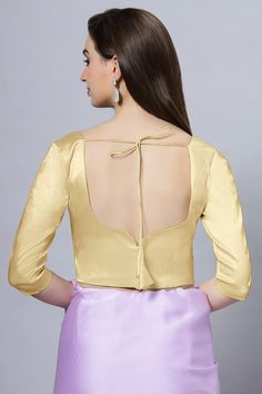 Our Satin Comfort Stretch collection blouses are made to impress and made to be worn all day. Made from the finest satin-cotton blend stretchable fabric, it holds its shape and shine while offering the comfort of stretchable material. Wear it with your favorite saree, as a crop top or lehenga choli! Item Type: Saree blouse / Crop top Product Features: Color: Gold Fabric: Satin Stretch Trim: Back Dori Neck Style: Leaf, Front & Back Sleeve Length: Elbow Sleeve Closure: Back Hook Padded: No Occasio Fitted Party Blouse In Solid Color, Stretch Padded Long Sleeve Blouse, Elegant Padded Stretch Blouse, Elegant Stretch Padded Blouse, Fitted Satin Tops In Solid Color, Fitted Gold Padded Blouse, Fitted Solid Satin Tops, Fitted Solid Color Satin Tops, Fitted Long Sleeve Satin Blouse