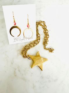 Introducing our stunning North Star statement necklace, which features a bold hammered 12k gold over brass star suspended from a chunky gold-plated brass chain. A dangle of Gold-plated beads with bezel set crystals have been added for a touch of sparkle. Handcrafted with precision and attention to detail, it’s the perfect accessory to add a touch of celestial charm to your look. Chain is adjustable and can be worn short 18 " or lengthened up to 21". The pendant adds additional 1.75 inches. Wear Bohemian Star-shaped Gold Jewelry, Bohemian Gold Star Jewelry, Brass Dangle Jewelry With Star Charm, Gold Brass Necklace With Star Charm, North Star Necklace, North Star, Brass Chain, Star Necklace, Ring Bracelet