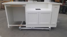 a white counter sitting on top of a metal cart