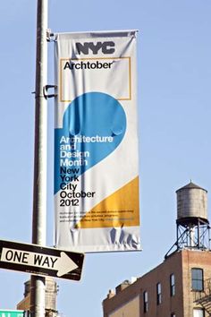 two street signs on a pole with buildings in the background and one sign that says art architecture design museum