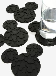 black mickey mouse coasters next to a glass of water