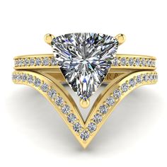 a white gold ring with a pear shaped diamond in the center and side stones on each band