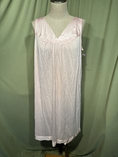 This lovely vintage nightgown is from the 1970s. Labeled Vanity Fair. Tagged a size Large. Bust measures 42", see measurements below.   Made of nylon in pink with floral applique trim at the neckline. The gown slips over the head and sleeveless. The gown reaches to the knee or a little beyond. Condition is very good.  No soil, wear or stains. Deadstock, never worn! Charming! Measure yourself & know your measurements before buying! Please remember that vintage sizes run small. It is best to measu Sleeveless Pink Nightgown For Sleep, Pink Sleeveless Nightgown For Bedtime, Pink Sleeveless Nightgown For Sleep, Vintage Sleeveless Dress For Sleepover, Vintage Pink Sleeveless Nightgown, Pink Sleeveless Vintage Nightgown, Sleeveless Nightgown For Hospital, Vintage Sleeveless Nightgown For Bedtime, Vintage Sleeveless Night Dress