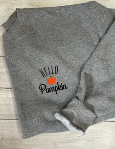 Hello Pumpkin Embroidered Sweatshirt MATERIAL: -Gildan Heavy Blend -50/50 Cotton/Polyester -Unisex Crewneck Sweatshirt SIZE AND FIT: -Sizes are unisex sizes from S - 3x (If you need a different size than listed please message me before purchasing so I can see if I can get you what you need) -Please see photo for the fit chart -For an oversize fit, size up 2 sizes CARE:  -Machine wash cold -Tumble dry low or hang dry PERSONALIZATION AVAILABLE: -If you wish to have the color of the threads changed, please message before purchasing, I am more than happy to embroider in the colors you'd like at no extra charge! PROCESSING: -Your new sweatshirt is made to order  -Please allow 1-2 weeks processing time  -Tracking number is provided when your order has been shipped Long Sleeve T-shirt With Embroidered Graphics For Fall, Casual Embroidered Fall T-shirt, Casual Embroidered T-shirt For Fall, Black Embroidered T-shirt For Fall, Casual Fleece T-shirt For Fall, Fall Cotton T-shirt, Crew Cotton Sweater For Fall, Black T-shirt With Custom Embroidery For Fall, Long Sleeve T-shirt With Embroidered Logo For Fall