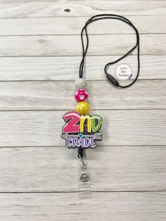 "School themed lanyards with interchangeable toppers! Add a little fun to your lanyard 💜 approx 2\" interchangeable acrylic badge reel topper that snaps securely to the badge reel secured to a breakaway nylon lanyard with bright chunky beads.  Acrylic badge reel toppers are handmade and may have their own unique differences. Take care to not drop or bump the acrylic topper against hard surfaces. Wash with gentle cloth (will withstand most hospital grade wipes/sanitizers). Keep out of direct heat." Personalized Multicolor Badge Reel For Teacher Appreciation, Novelty Adjustable Badge Holders For School, Personalized Fun Badge Reel For Hobbies, Multicolor Fun Badge Holders For Hobby, Novelty Personalized Adjustable Badge Holders, Personalized Fun Badge Reel For Hobby, Personalized Multicolor Fun Badge Holder, Themed Multicolor Badge Holders For Gift, Themed Multicolor Badge Holders As Gifts