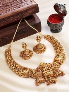 This jewellery set consists of a necklace and a pair of earrings The gold-plated choker necklace has red Artificial stone-studded details Secured with a drawstring closure A pair of matching drop earrings, each secured with a post-and-back closure Size & Fit Necklace: 26 cm(Length) Earrings: 4.5 cm(Length) Material & Care Material: Alloy Plating: Gold-plated Stone Type: Artificial Beads Dispatch within 7 days Heavy Temple Jewelry Necklaces As Gift, Heavy Pendant Necklace As A Gift, Gold Temple Jewelry Necklaces As Gift, Festive Gold Plated Necklace For Gift, Gold Plated Necklaces For Festivals, Gold Plated Temple Jewelry Necklaces For Festivals, Gold Plated Temple Jewelry Necklace For Festivals, Temple Jewelry Necklaces With Matching Earrings For Festivals, Temple Jewelry Necklace With Matching Earrings As Gift