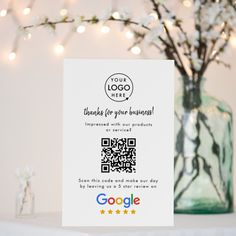 a card with qr code on it sitting next to a vase filled with flowers