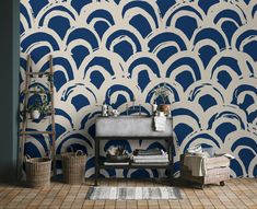 a bathroom with blue and white wallpaper that looks like an art deco fan pattern