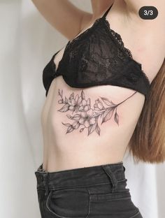 a woman with a flower tattoo on her stomach