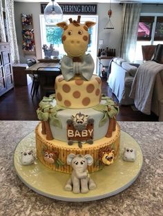 a giraffe themed baby shower cake on a table