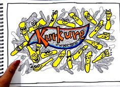 a person holding up a drawing with the word kurkure written in front of them