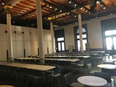 tables and chairs are lined up in an empty room