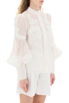 Zimmermann button-up blouse in linen silk organza, embellished with floral appliques and tonal beaded trimmings. Detailed with pearl-shaped buttons, it features a Mandarin collar, bouffant sleeves with long zip cuffs, and a removable jersey camisole with adjustable straps. The model is 177 cm tall and wears a size 1 Zimmermann. Size Info STANDARD Color Detail White Made In China Material 52%LI 48%SE Season One spring Season Two summer Product clothing Brand Zimmermann Size And Fit Luxury Long Sleeve Blouse For Wedding, Luxury Long Sleeve Tops For Wedding, Luxury Long Sleeve Wedding Blouse, Elegant Fitted Tops With Embroidered Cuffs, Formal Long Sleeve Blouse With Embroidered Cuffs, Elegant Blouse With Embroidered Sleeves For Wedding, Elegant Wedding Blouse With Embroidered Sleeves, Elegant Formal Blouse With Embroidered Sleeves, Elegant Tops With Embroidered Cuffs