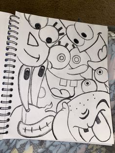 a drawing of some cartoon characters on a sheet of white paper with black marker markers