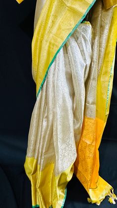 Bringing you the finest collection of Banarasi Tissue Silk Sarees yet another stylish , elegant and timeless piece from our master weavers in Banaras. Adorn this Kanchipuram inspired tissue silk saree in gold zari with floral jaal all over. With double border on the bottom and contrast color pallu this piece is gorgeous to the core and timeless . Luxurious fabric with softness and sheen just remarkable. Photos don't do justice .. this saree is just... glamorous Comes with fall/ Pico / tassels and a stitched blouse. Blouse Detail: Stitched blouse size 38, upto 42. front closure and padded with elbow level sleeves. Saree comes in a beautiful saree cotton bag. Note: Colors that show up on your screen may vary slightly from the actual product due to variations in settings. Also, the actual pro Gold Pre-draped Saree With Traditional Patterns For Festivals, Elegant Yellow Traditional Wear For Festive Occasions, Gold Pre-draped Saree With Cutdana In Traditional Drape, Yellow Traditional Wear With Zari Work For Transitional Season, Transitional Traditional Wear With Zari Work In Yellow, Transitional Season Anarkali Yellow Saree, Transitional Yellow Anarkali Saree, Gold Traditional Wear With Cutdana For Transitional Season, Transitional Season Yellow Anarkali Saree