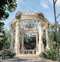 an outdoor gazebo with statues and flowers around it