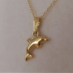 18ct Gold over Sterling Silver Dolphin Pendant Necklace pendant dimensions: 9mm wide x 19mm drop material: 18ct gold over sterling silver. Affordable Necklaces, Dolphin Pendant, Creole Earrings, Diffuser Jewelry, Bar Pendant, Cross Charms, June Birth Stone, Earrings Photo, Gorgeous Necklaces