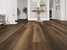 a living room with white walls and wooden flooring that has been painted in shades of brown