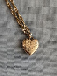 Vintage antique 12k yellow gold filled heart shaped locket pendant on a vintage gold tone necklace chain.  This locket shows wear and patina average for its age.  It is signed.  It did not come with the necklace chain, I added it so it would be ready to wear.  The necklace chain is gold tone only, not gold karat.  The chain is free, so it does show a little wear and age but it was the best I had available to place the locket on. Vintage Antique Gold Heart Pendant Necklace, Antique Gold Heart Pendant Vintage Necklace, Vintage Charm Necklace With Heart Pendant For Memorial, Vintage Yellow Gold Heart Charm Necklace, Vintage Charm Necklaces With Heart Pendant For Memorial, Vintage Heart Pendant Necklace For Memorial, Vintage Yellow Gold Heart Necklace, Heart Pendant Necklace With Vintage Charm For Memorial, Vintage Necklaces For Valentine's Day Memorial