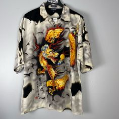 Korean Dragon Shirt Nwt Y2k Deadstock Vintage Korean Sports Shirt. This Incredible Short Sleeved Button Down Shirt Has The Coolest Orange, Yellow And Red Dragon Design On Both The Front And Back. Flowy Comfortable Fabric. This Item Has Not Been Worn Or Washed And Has Its Original Tags. Size Xxl Pit To Pit 26 Inches, Length 32 Inches #Dragon #Vintage #Korean #Alt #Y2 Yellow Graphic Print Button-up Shirt, Yellow Button-up Shirt With Graphic Print, Yellow Printed Tops With Camp Collar, Yellow Graphic Print Button-up Top, Yellow Button-up Top With Graphic Print, Yellow Printed Collared Shirt, Yellow Relaxed Fit Collared Hawaiian Shirt, Korean Dragon, Dragon Shirt