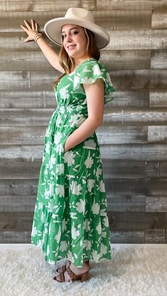 FINAL SALE this green and white floral dress from wishlist is giving me vacay vibes! perfect for a night out, sipping your favorite bev. it's also a lovely dress for a summer wedding or a bridal shower. a maxi dress with flutter sleeves, an elegant neckline, smocking at the waist and back, with a tiered skirt. it's lined and has pockets. you will look timeless in this dress. pair with some subtle jewelry and accessories and the perfect sandals to complete the look! our model is wearing a size sm Green Maxi Dress With Floral Print For Garden Party, Spring Green Floral Print Maxi Dress, Green Maxi Sundress For Brunch, Green Floral Print Maxi Dress For Spring, Green Floral Maxi Dress For Garden Party, Green Sundress Maxi Dress For Brunch, Green Midi Floral Dress For Vacation, Spring Green Floral Print Midi Dress, Green Midi Sundress For Brunch