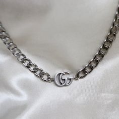 Authentic GG logo choker necklace made with a pendant from a vintage Gucci multiple logo necklace (see last photo for original piece). necklace length: adjustable 14-16 inches pendant measurement: approximately 15mm wide necklace material: stainless steel lobster clasp closure Jewellery Wishlist, Wide Necklace, Jewelry By Brand, Logo Necklace, Statement Choker, Gg Logo, Bag Charms, Black Choker, Button Jewelry