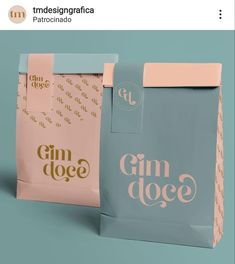 two paper bags with the words gin dole printed on them, one blue and one pink