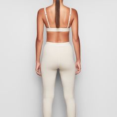 These cotton leggings hug the body yet allow your skin to breathe with cool and comfy natural fibers. The classic, rustic design elevates your lounge look. | SKIMS Legging | White | Cotton Rib Fitted Full Length Ribbed Activewear, High Stretch Ribbed Elastane Leggings, Fitted Ribbed Athleisure Leggings, Fitted Ribbed Leggings For Athleisure, Fitted Ribbed Yoga Pants, Sporty Seamless Elastane Leggings, Sporty Stretch Ribbed Pants, Tight Ribbed Leggings For Loungewear, Fitted Ribbed Tights For Loungewear