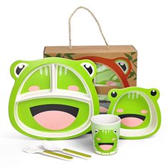 a green frog dinnerware set with matching utensils