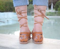 "The SOPHIA, which is Greek for \"wisdom\", is a leather, lace-up, gladiator sandal, with a toe ring detail. Suitable for those who prefer a closed heel, intricate design. Choose to tie at ankle level or knee height for the full gladiator effect. Pair it in matte colours with a pair of summer pants in a fancy print, or tied up high on the leg with your jean shorts and a simple shirt, and let them be the stars of your look. ALL ORDERS ARE SHIPPED VIA TNT EXPRESS WORLDWIDE (Please include a phone Adjustable Lace-up Sandals With Single Toe Strap For Spring, Leather Lace-up Sandals For Spring Festival, Spring Festival Lace-up Ankle Strap Sandals, Brown Ankle Tie Sandals For Spring, Spring Brown Ankle Tie Lace-up Sandals, Adjustable Strappy Toe Ring Sandals For Festivals, Adjustable Leather Lace-up Sandals For Festivals, Brown Toe Ring Sandals For Spring, Ankle Tie Lace-up Sandals For Spring Festival