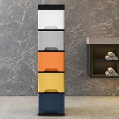 a bathroom with marble walls and tile flooring, including a multi - colored cabinet