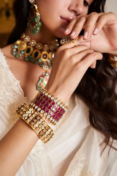 Step into refined elegance with the Sadhika kundan bangles, a perfect blend of tradition and contemporary style. These bangles showcase exquisite kundan craftsmanship, featuring intricate designs that shimmer with every movement. Ideal for festive occasions, they add a touch of regal charm to your outfit, ensuring you stand out with grace and sophistication. Elegant Festive Cutdana Bangle, Elegant Cutdana Bangle For Diwali, Elegant Kundan Bangle, Elegant Meenakari Bangle For Festive Occasions, Fusion Style Cutdana Bangle For Diwali, Fusion Style Cutdana Bangle For Festivals, Fusion Cutdana Bangle For Diwali, Elegant Hand Set Kundan Bangle, Elegant Gota Work Bangle As Gift