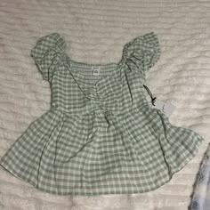 Super Cute Babydoll Top. Gingham Print In A Light Green And Has Never Been Worn Before With Tags Still Intact! Cute Fitted Green Blouse, Playful Plaid Summer Tops, Cute Gingham Blouse For Summer, Gingham Tops For Beach In Spring, Cute Fitted Tops For Picnic, Cute Plaid Short Sleeve Tops, Cute Short Sleeve Plaid Tops, Plaid Short Sleeve Beach Top, Cute Gingham Tops For Summer