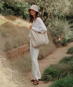 Linen Bucket Hat Natural Inspired by fisherman styles, our elevated take on the classic bucket hat is the summer’s definitive beach bag essential. 100% linen. Made in Portugal. | Jenni Kayne Women's Linen Bucket Hat Size Medium/Large Summer Outfits Bucket Hat, Fisher Hat Outfit, Linen Bucket Hat, Fisherman Hat Outfit, Bucket Hat Summer Outfit, Bucket Hat Beach, Bucket Hat Outfit, Beach Bag Essentials, Bucket Hat Summer