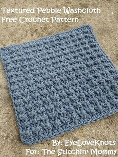 a blue crocheted square sitting on top of a sandy ground with text that reads, textured pebble washcloth free crochet pattern