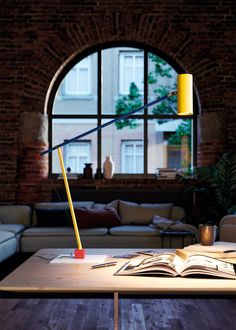 The Ettorino Table Lamp offers an updated take on the classic design of articulated desk lamps. Ettorino features an adjustable arm that can be raised and lowered and a swiveling cylindrical head to aim light precisely where it is needed for reading and other tasks. The lamp's form is composed of simple geometric shapes for a versatile look with a modern expression. A small detail of a dancing figure at the end of the arm completes the look with a charming accent. Dimmer switch located on cord. Indoor Lamps, Dancing Figures, Three Primary Colors, Primary Colours, System Design, Indoor Lamp, Art Deco Stil, Estilo Art Deco, Entry Foyer