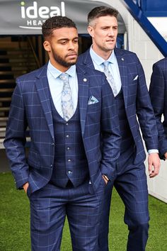 Sport a winning look with the Edinson navy blue three piece suit in sky check, the official West Bromwich Albion F.C. club's suit. As worn by Darnell Furlong, Grady Diangana, Martin Kelly & Okay Yokuşlu. In a rich navy blue with a subtle Prince of Wales check and overlayed with a soft sky blue windowpane check, this suit is made with added elastane, to work with you from desk to dance floor. Features Slim fit Single-breasted Notch lapel Single back vent Four button cuff Double button blazer fast Navy Blue Window Pane Suit, King And Allen Suits, Blue Windowpane Suit Men, Blue Plaid Suit For Men, Navy Blue Mens Suits Wedding, Navy Prom Suit, Navy Blue Suits, Wedding Suits Men Blue, Prince Of Wales Suit