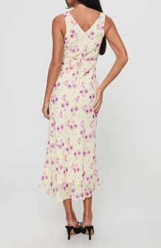 A dreamy floral print covers this slinky dress cut in a sleeveless silhouette and cinched at the waist by a back tie accent. 51" length Hidden side-zip closure V-neck Sleeveless Attached waist tie Lined 100% polyester Machine wash, tumble dry Imported Spring Sleeveless Maxi Dress With Ruched Back, Sleeveless Ruched Floral Dress For Spring, Sleeveless Ruched Back Maxi Dress For Brunch, Sleeveless Maxi Dress With Ruched Back For Brunch, Flowy Spaghetti Strap Sleeveless Dress With Floral Print, Flowy Sleeveless Dress With Spaghetti Straps And Floral Print, Sleeveless Floral Dress With Smocked Back For Spring, Sleeveless Fitted Floral Dress With Tie Back, Floral Sleeveless Tie Back Dress For Brunch