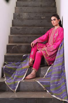 Channeling the old world charm of a kalidar kurta paired with shalwar, Serina is a striking hot pink number cut from pure rawsilk. The undulating trail of the geometric lime green and lavender contrasting organza dupatta hones in the ethereal aura. Model height: 5'3 Length: 38" Cut: relaxed fit In this price range, the Festive Slub Silk Salwar Kameez With Naqshi, Festive Naqshi Slub Silk Salwar Kameez, Designer Raw Silk Purple Salwar Kameez, Designer Wear Purple Raw Silk Salwar Kameez, Designer Purple Raw Silk Salwar Kameez, Silk Churidar With Naqshi For Diwali, Festive Tissue Silk Salwar Kameez With Naqshi, Designer Naqshi Salwar Kameez In Tissue Silk, Anarkali Salwar Kameez In Tissue Silk With Naqshi