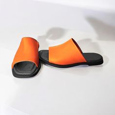 These elegant handcrafted leather slides are designed for comfort and style during the summer months. With a low sole height ranging from 1 to 1.5 cm, they fit perfectly to the foot, providing all-day comfort. Made from high-quality genuine leather, these slides are available in a variety of colors, making them suitable for any outfit and occasion. The perfect choice for summer, these slides combine durability with modern design. Materials: Genuine leather, Patent  Leather Sole: Stylish and Comf Summer Leather Footbed Slip-on Slides, Leather Slide Slippers For Beach, Leather Flat Heel Mules For Beach, Beach Slip-on Mules With Leather Footbed, Vacation Mules With Rubber Sole And Slide Shape, Vacation Slide Mules With Rubber Sole, Summer Leather Mules With Rubber Sole, Summer Leather Closed Toe Mules, Orange Leather Sandals For Vacation