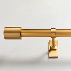 a close up of a gold curtain rod