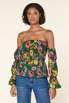 Autumn is in full bloom in the Everly Floral Off the Shoulder Smocked Peplum Top. Perfect for warmer autumn days, this top features a smocked bodice with a peplum waist. Smocked off the shoulder sleeves are attached. Complete the look with light wide leg pants and strappy heels for a flirty look.- Smocked bodice- Off the shoulder- Smocked sleeves- Peplum- Color: Green MultiSize + Fit - Model is 5'9" and wearing size XS- Measurements taken from size S - Chest: 29"- Length: 31 1/2" fabricSelf: 100 Summer Multicolor Top With Smocked Cuffs, Multicolor Summer Top With Smocked Cuffs, Spring Vacation Top With Smocked Cuffs, Spring Peasant Top With Smocked Back, Spring Vacation Tops With Smocked Cuffs, Green Summer Blouse With Smocked Cuffs, Summer Green Blouse With Smocked Cuffs, Green Long Sleeve Tops With Floral Print, Summer Top With Smocked Bodice For Garden Party