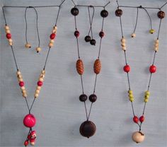 several necklaces are hanging on a wall with beads and wood bead details in different colors