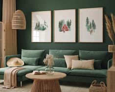 a living room with green walls and pictures hanging on the wall above the couches