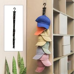 an umbrella hanging on the wall next to a book shelf with books and other items