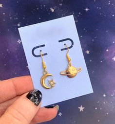 "🎁 Holiday gift wrap is now available!  Cute pair of mismatched gold-tone earrings, one with a moon moon and one with a Saturn charm. The card and white gift box are included, as shown. Perfect gift for a friend or to treat yourself! The french wire earring hooks are hypoallergenic gold-tone metal and are lead-free and nickel-free. They come with silicone stoppers. The charms are metal alloy. Every order includes a free random ts sticker as a thank you gift from me to you :) I offer gift wrapping for this item. Click on \"this order is a gift\" at checkout for details. Check out my shop for more ts jewelry, including the coordinating necklace: https://www.etsy.com/listing/1408230337/moon-saturn-necklaces-gold-chains-and?click_key=e80d99b19369e6d34dae3dd5a66f31d9d96dcb57%3A1408230337&click Celestial Single Earring Jewelry Gift, Celestial Single Earring Jewelry For Gift, Gold Symbolic Moon Charm Earrings, Gold Symbolic Earrings With Moon Charm, Symbolic Gold Earrings With Moon Charm, Symbolic Gold Moon Earrings, Symbolic Gold Moon-shaped Earrings, Vintage Moon Earrings For Gift, Gold Moon Charm Drop Earrings