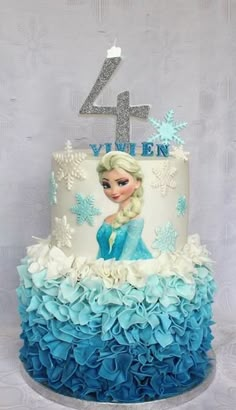 a frozen princess birthday cake with blue and white ruffles