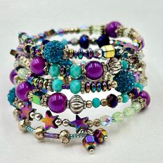 This Colorful And Bright 5 Row Wrap Bracelet Is Made On Silver Memory Wire With A Mixture Of Gorgeous Glass Beads, Silver Spacer Beads, Rainbow Hematite, And Endless Crystals And Sparkle. Whimsical Silver Beaded Adjustable Bracelets, Whimsical Adjustable Beaded Bracelets For Party, Bohemian Nickel Free Purple Bracelets, Bohemian Nickel-free Purple Bracelets, Bohemian Nickel-free Purple Bracelet, Bohemian Purple Nickel-free Bracelet, Bohemian Purple Bracelets For Party, Bohemian Purple Bracelet For Party, Bohemian Purple Crystal Bracelet For Party