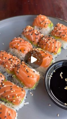 sushi rolls with sesame seeds and sauce on the side