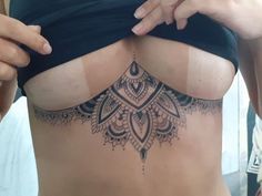 a woman with a tattoo on her stomach